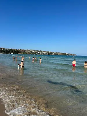 a group of people in the water at the beach at Cozy sea view studios in Sozopol