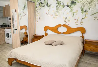 a bedroom with a bed with a flower wallpaper at Central Studios on Maria Luiza Street - Cozy Stay in Varna by Flat Mаnаger in Varna City