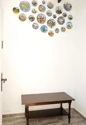 a bench in front of a wall with plates on it at Central Studios on Maria Luiza Street - Cozy Stay in Varna by Flat Mаnаger in Varna City
