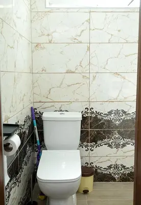a white toilet in a bathroom with a marble wall at Central Studios on Maria Luiza Street - Cozy Stay in Varna by Flat Mаnаger in Varna City