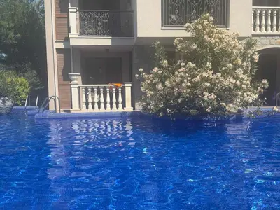 a house with a blue swimming pool in front of a house at Flat in Cascadas 21 in Sunny Beach