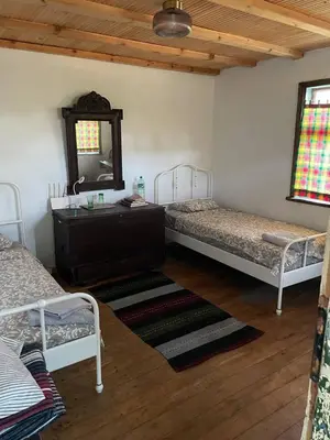 a bedroom with two beds and a dresser and a mirror at Villa Suhodol
