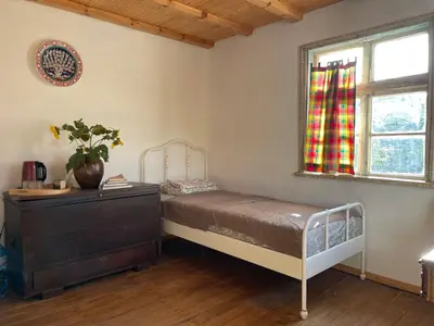 a bedroom with a bed and a dresser and a window at Villa Suhodol