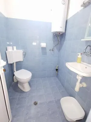 a bathroom with a toilet and a sink at Studio Garden City Center Pomorie in Pomorie