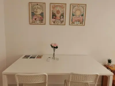 a white table with two chairs and a vase with flowers at Studio Garden City Center Pomorie in Pomorie
