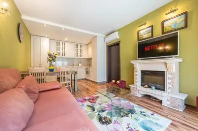 a living room with a couch and a fireplace at Kevin & Wes Central Apartment in Varna City