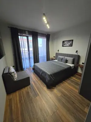 a bedroom with a bed and a couch in it at Villa Cadaques, private pool with heating and salt water in Lozenets