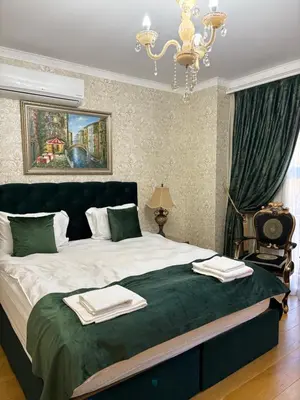 a bedroom with a large bed with two towels on it at Hogo Fogo in Burgas City