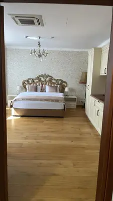 a bedroom with a bed with a chandelier at Hogo Fogo in Burgas City