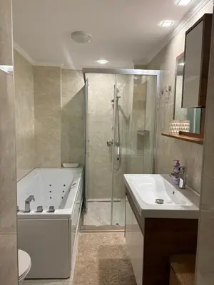 a bathroom with a shower and a tub and a sink at Hogo Fogo in Burgas City