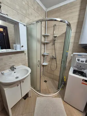 a bathroom with a shower and a sink at Комфортен Апартамент Лазур in Pomorie