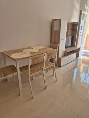 a wooden table and chairs in a room at Комфортен Апартамент Лазур in Pomorie