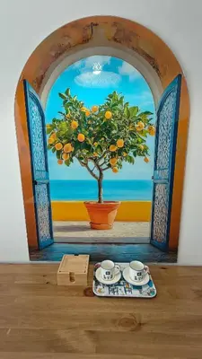 a painting of an orange tree in front of a window at Vivid Sea and City Luxury Studio 2 plus 2 in Burgas City