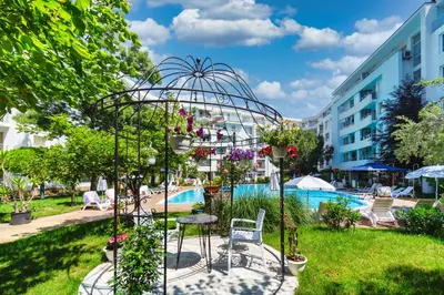 a garden with a swimming pool and a building at Apartment E 12 Yassen HV in Sunny Beach