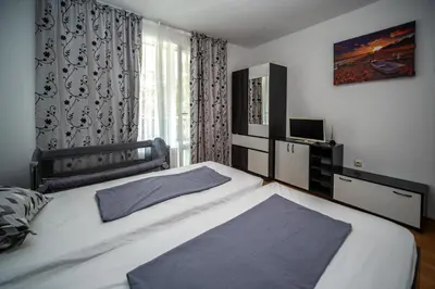 a bedroom with a large bed and a window at Apartment E 12 Yassen HV in Sunny Beach