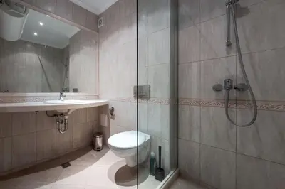 a bathroom with a shower and a toilet and a sink at АТ apartment - South Bay Beach Residence in Varna City