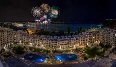 a view of a resort at night with fireworks at АТ apartment - South Bay Beach Residence in Varna City