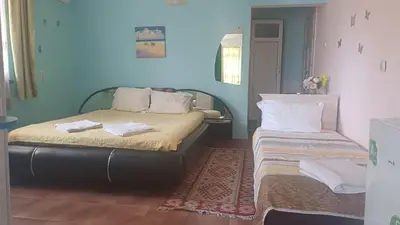 a bedroom with two beds with towels on them at Rooms Ivanka Ground Floor in Obzor