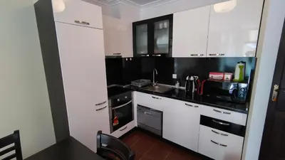 a kitchen with white cabinets and a sink at Dolche Vita 2, Banana Tree Stay in Sveti Vlas
