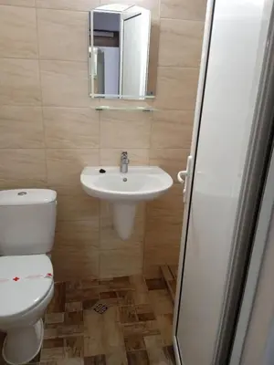 a bathroom with a sink and a toilet and a mirror at Hotel Park in Burgas City