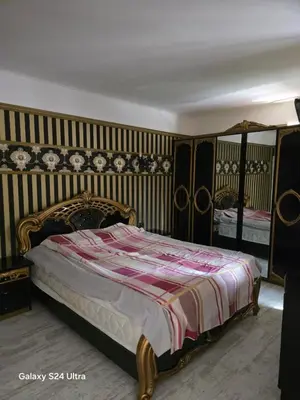 a bedroom with a bed and a striped wall at Несебър Златна Дюна in Nesebar