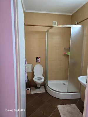 a bathroom with a toilet and a shower at Несебър Златна Дюна in Nesebar