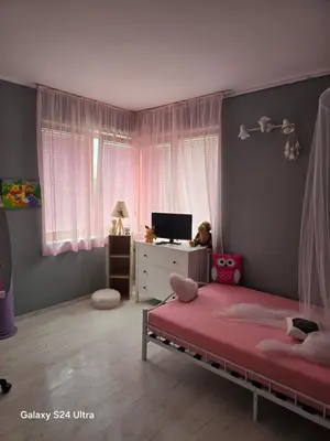 a bedroom with a bed and a tv in it at Несебър Златна Дюна in Nesebar