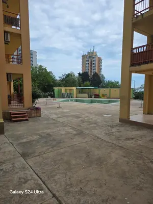 an empty parking lot in front of a building at Несебър Златна Дюна in Nesebar