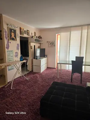 a living room with a table and a desk at Несебър Златна Дюна in Nesebar