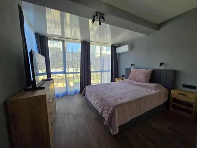 a bedroom with a bed and a large window at villa Amethyst, private pool with heating and salt water in Lozenets