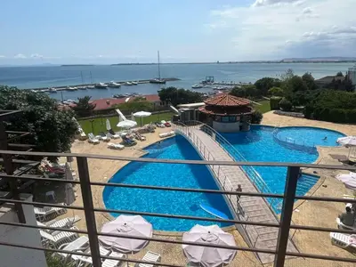 a view from the balcony of a resort with a swimming pool at Private apartment in complex Diamond in Sveti Vlas