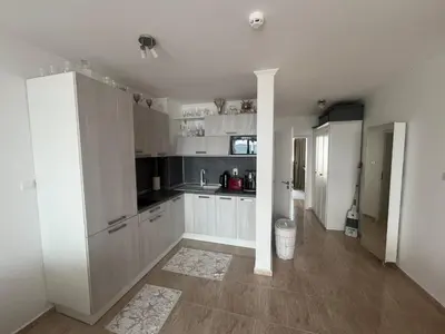 a kitchen with white cabinets and a counter top at Private apartment in complex Diamond in Sveti Vlas