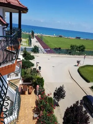 arial view of a building with flowers and the ocean at Sunny Island Obzor in Obzor