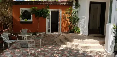 a patio with a table and chairs in front of a house at Sunny Island Obzor in Obzor