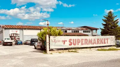 a sign in a parking lot next to a building at Velika Garden Villas 1 bedroom apartment, Lozenets in Lozenets