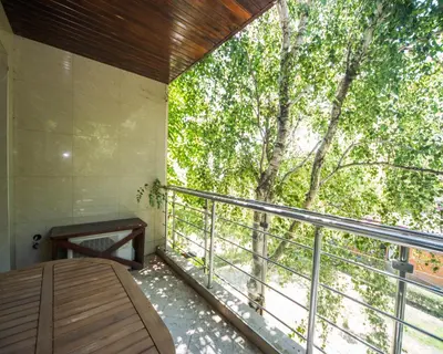 a room with a balcony with a large tree at Lovely 2 bedrooms Flat - 1st line Central Beach Lozenets in Lozenets