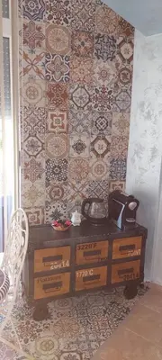 a room with a tiled wall with a telephone at Delfin beach studio in Sozopol