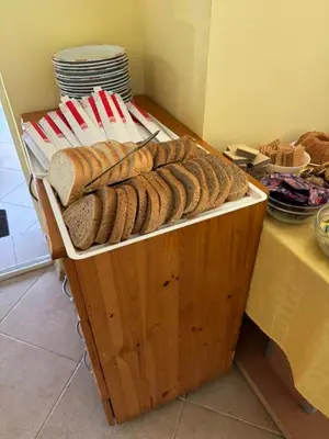 a bunch of loaves of bread sitting on a shelf at Хотел Грация in Lozenets