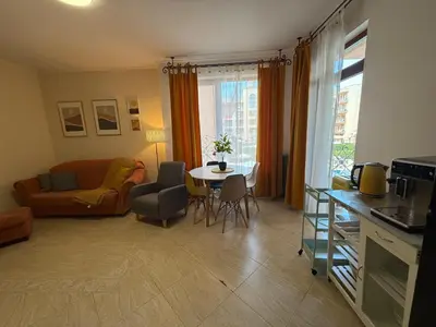 a living room with a table and a couch at Palazzo SP apartments-Sunny Beach in Burgas City