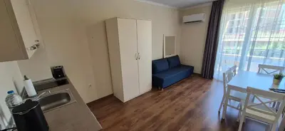a living room with a blue couch and a table at Apartment Sofia Macon Residence Sveti Vlas in Sveti Vlas