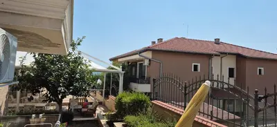 a house with a fence next to a house at Apartment Sofia Macon Residence Sveti Vlas in Sveti Vlas