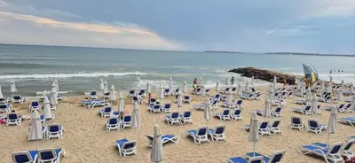 a bunch of chairs and chairs on a beach at Apartment Sofia Macon Residence Sveti Vlas in Sveti Vlas