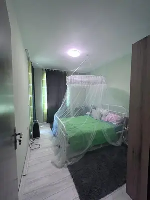 a bedroom with a bed with a net on it at морско бижу in Byala