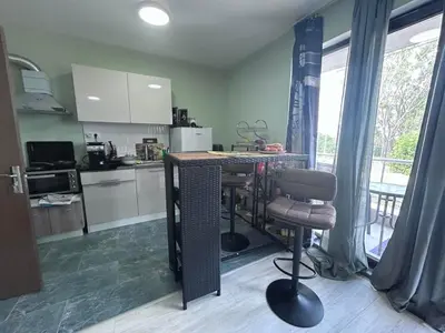 a kitchen with a table and a chair in it at морско бижу in Byala