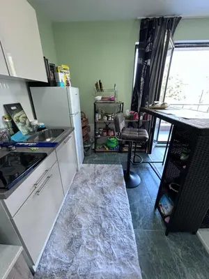 a kitchen with a refrigerator and a table in it at морско бижу in Byala