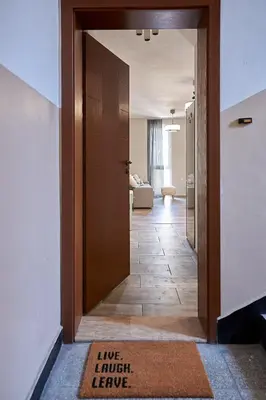 a door leading into a living room with a rug at Green Corner Apartment in the Center - 2BD in Burgas City
