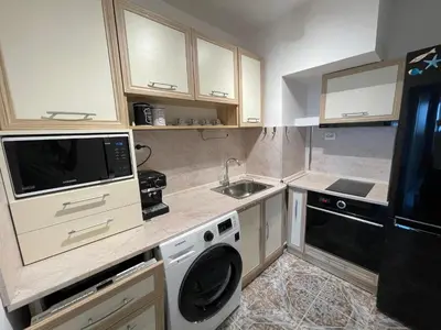 a small kitchen with a sink and a dishwasher at Sky Sea Apartment in Burgas City