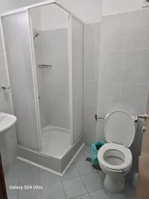 a bathroom with a shower and a toilet at Апартамент Хелиос Поморие in Pomorie