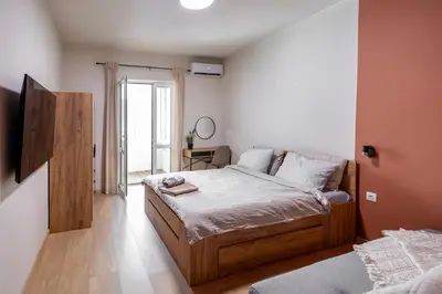 a bedroom with a bed with a wooden frame at City Center Gem Varna - 5 Guests in Varna City