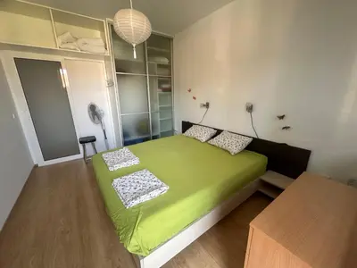 a bedroom with a green bed in a room at Sunny Seasons top view apartment SEA&POOL in Byala